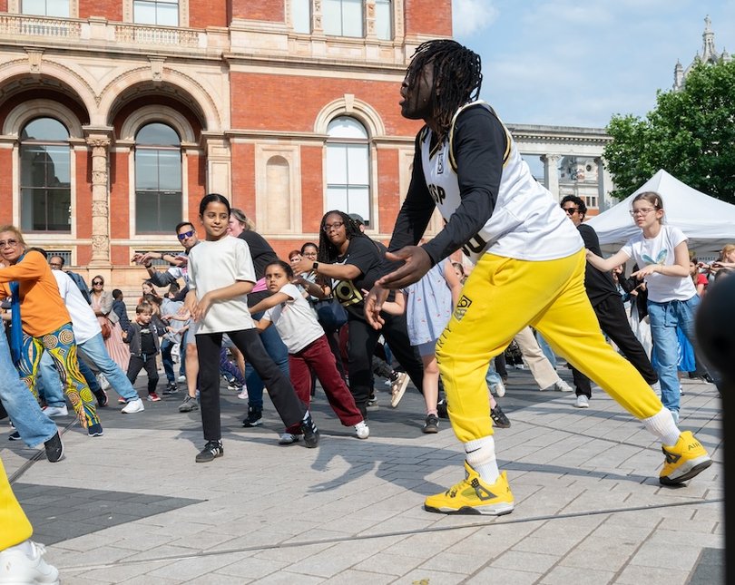Street dance performers doing moves on Exhibition Road