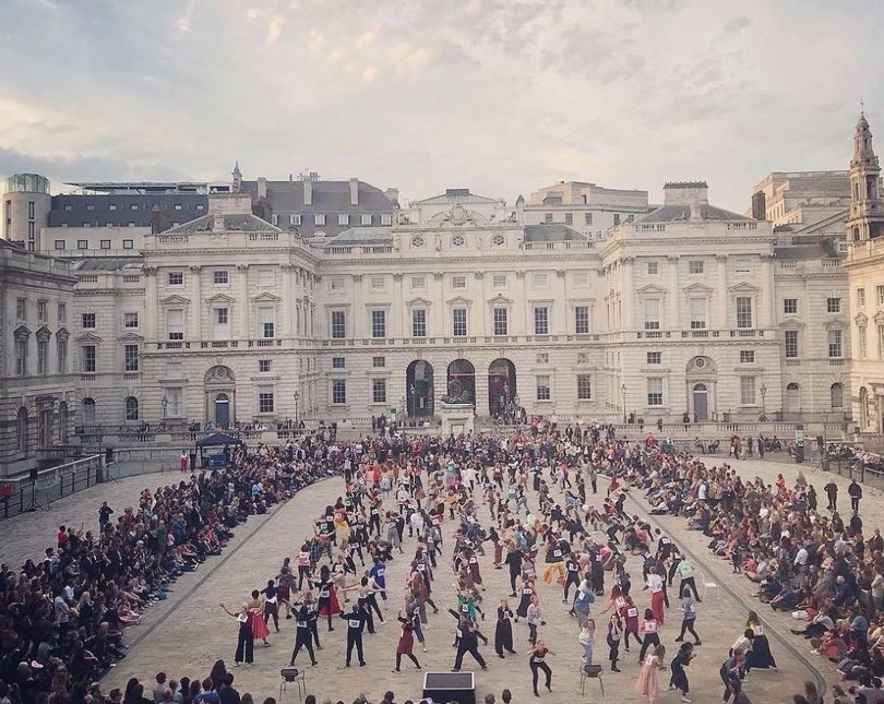 Image of large crowd of people dancing in square