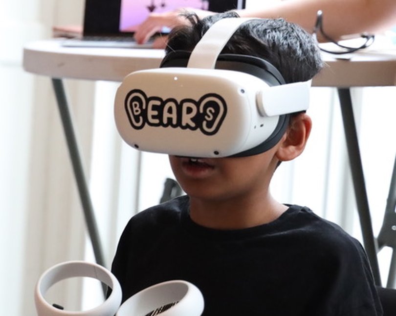 A boy wearing a white VR headset