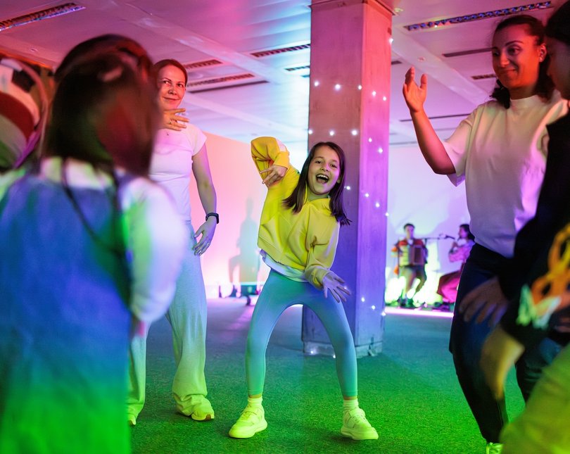 A young girl and her family dancing