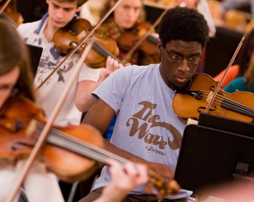A group of musicians playing the violin