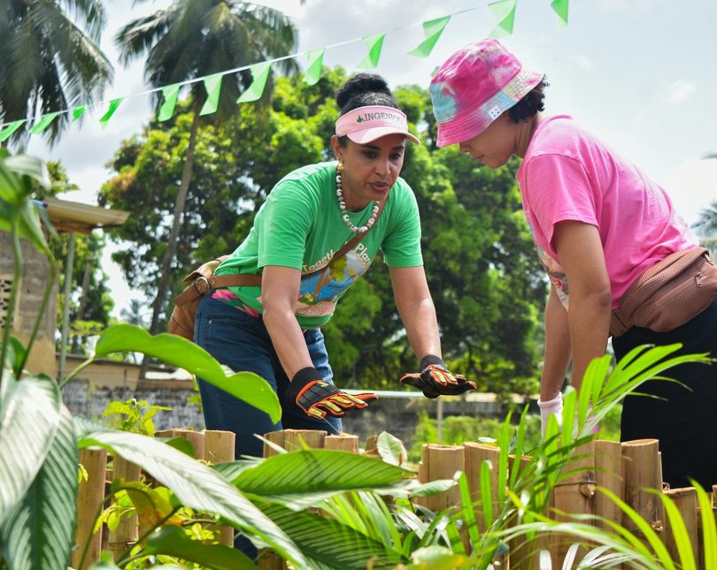 Two women gardening in a tropical country