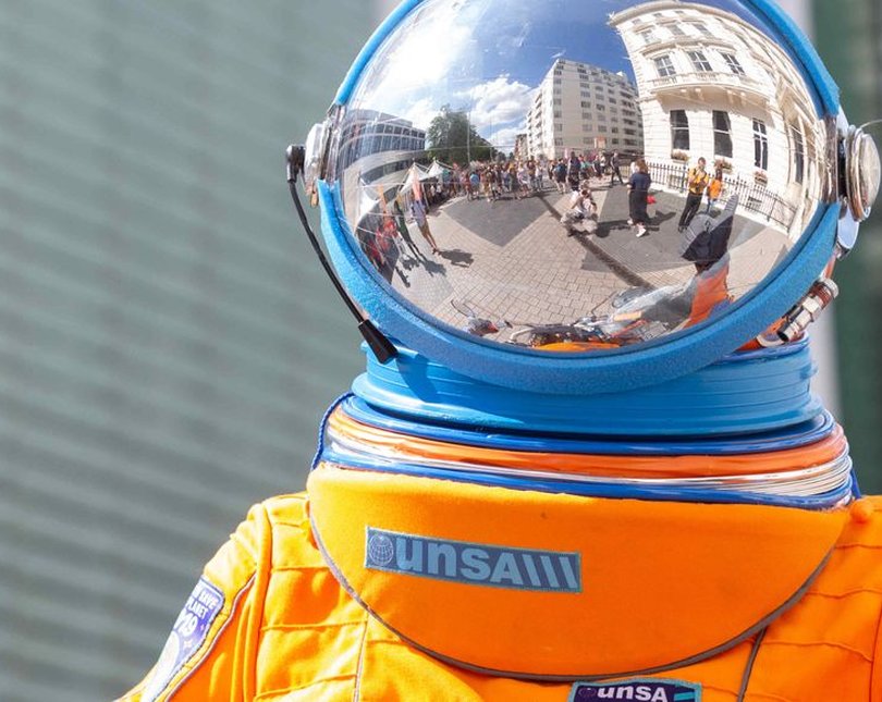 An orange and blue space suit