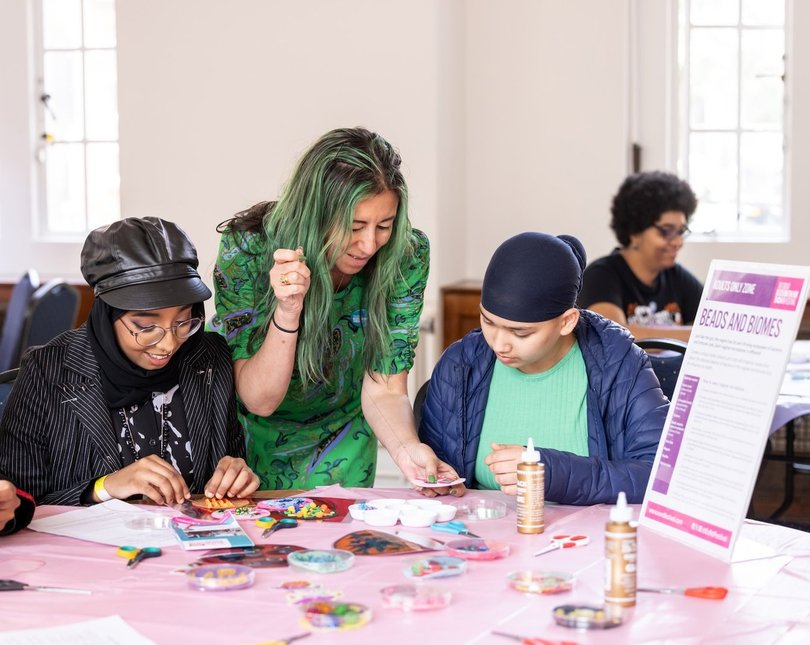 Two participants and workshop leader taking part in a sewing/crafting workshop