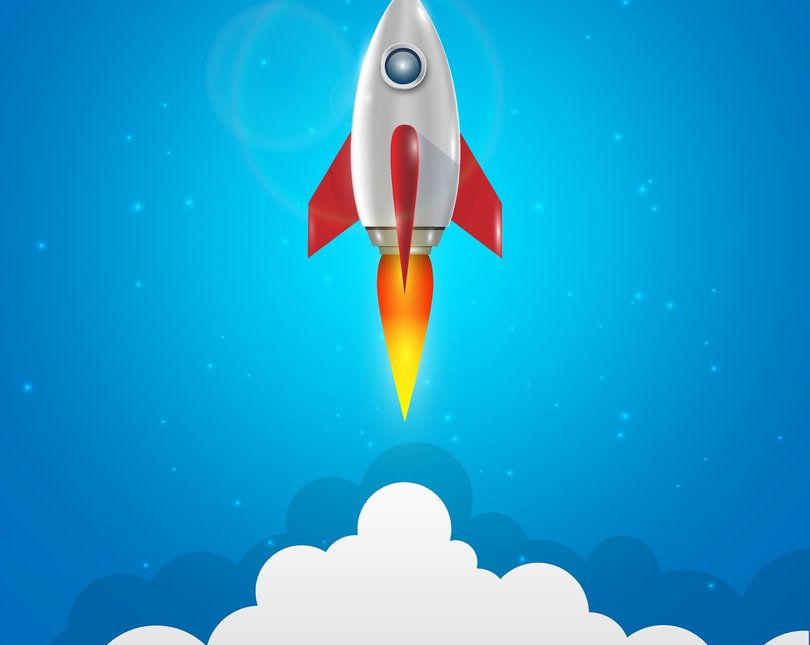 A cartoon rocket takes off against a blue background