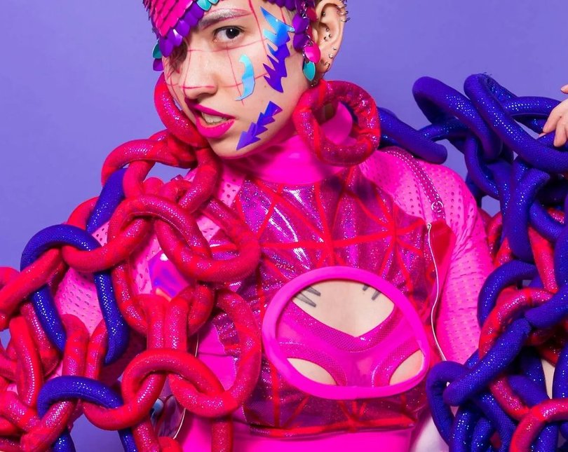 Woman in elaborate purple and pink outfit