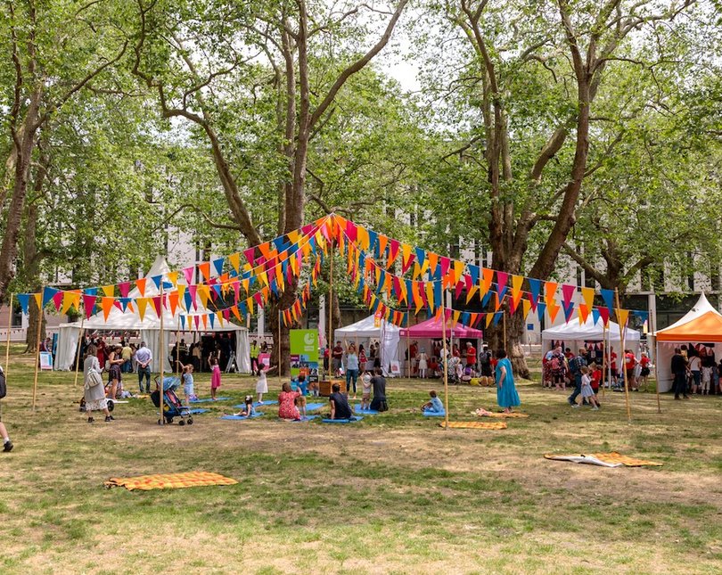 Large colourful maypole with bunting in a garden