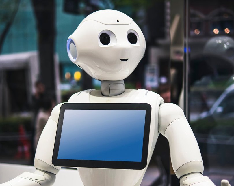 Friendly looking robot with a tablet on its chest