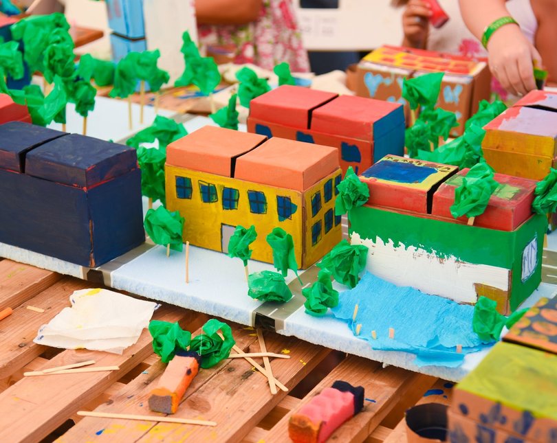 A cardboard model of a city painted in bright colours