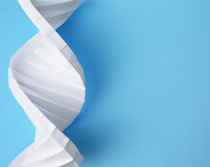 A white paper DNA chain on a blue background