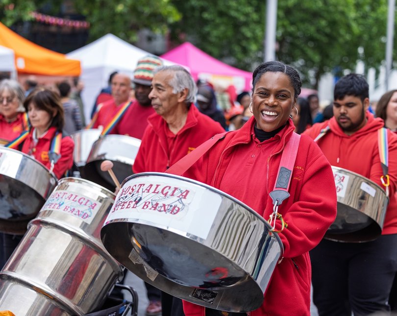 Woman playing a steelpan in a parade