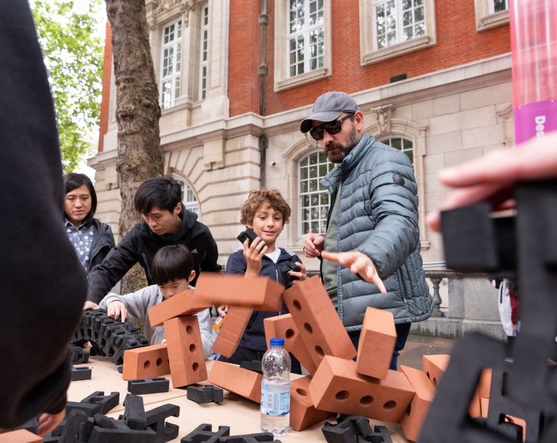 Family doing soft brick activity outside Dyson building
